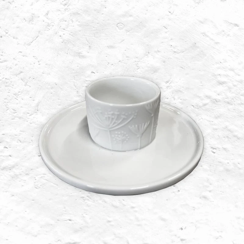 Porcelain floral egg cup and saucer by Rader